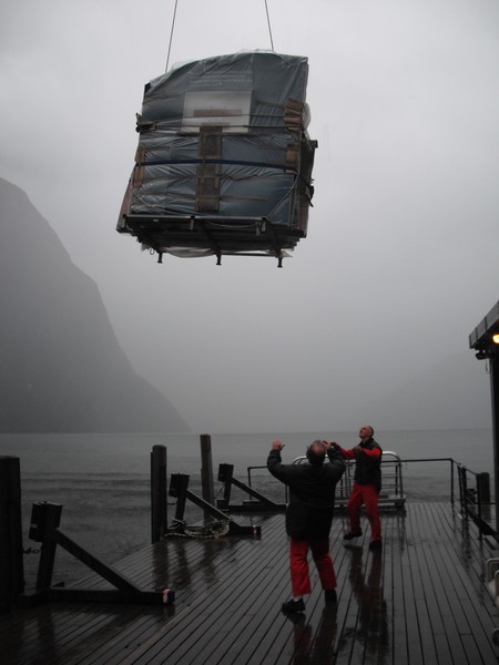 John Stitt (front) and Nick Pauson of the Southern Discoveries' Milford maintenance team help gently lower panels to the Discovery Centre pontoon